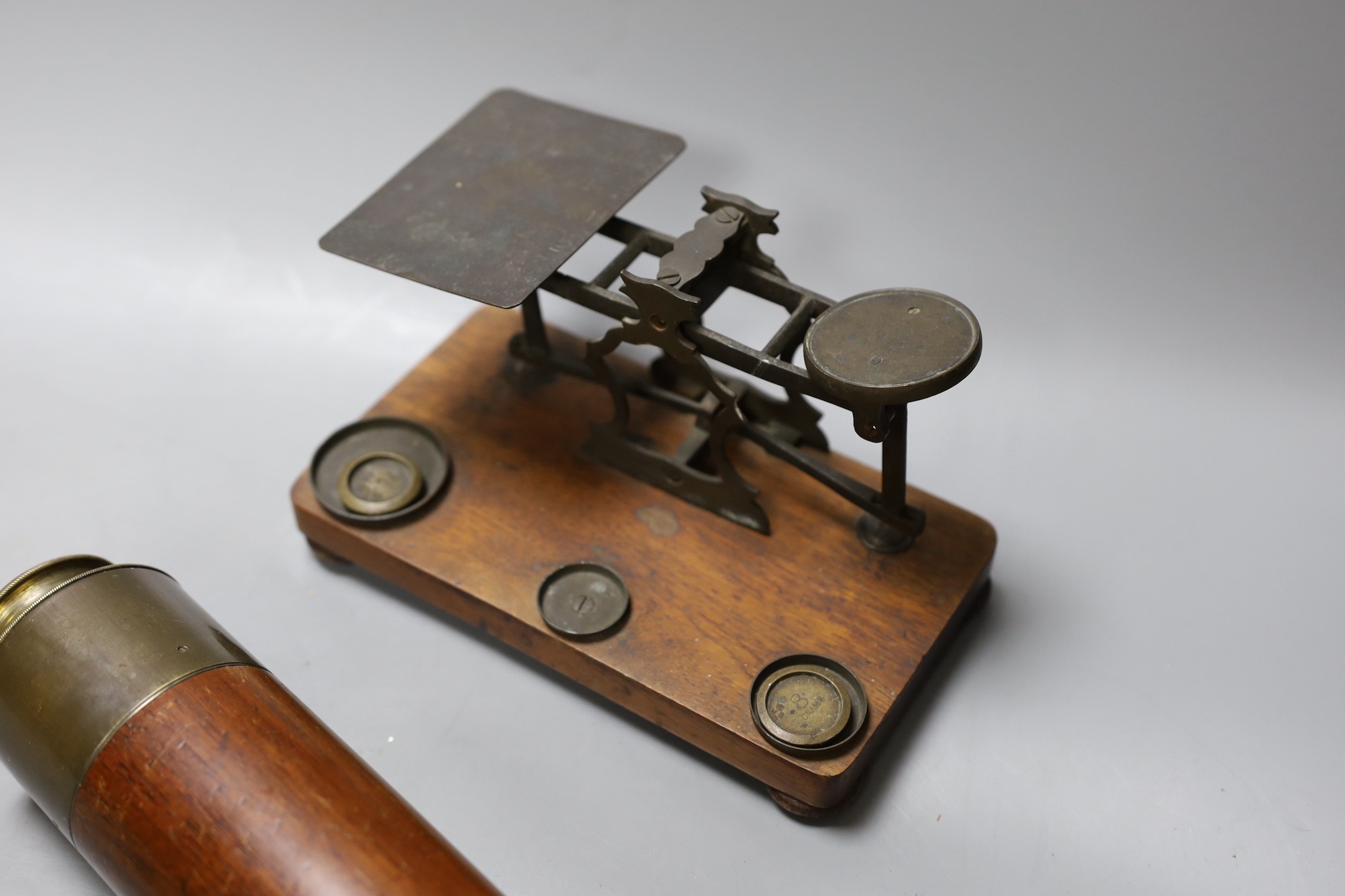 A five draw telescope, a pair of cased binoculars, postal scales and a brass timepiece, telescope drawn 69 cms long